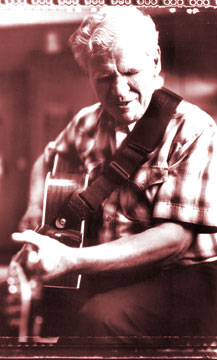 Doc Watson playing guitar